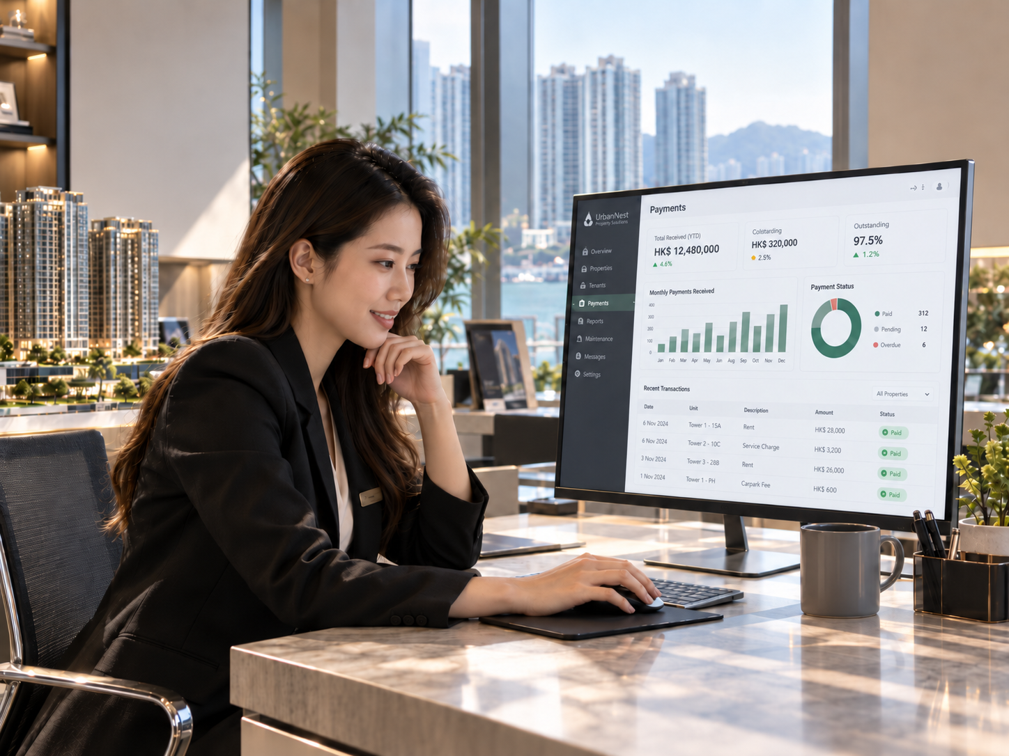Asian property manager reviewing payment activity on a desktop monitor in a Hong Kong real estate office with harbour views